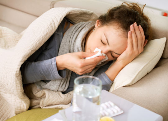 Sick Woman. Flu. Woman Caught Cold. Sneezing into Tissue