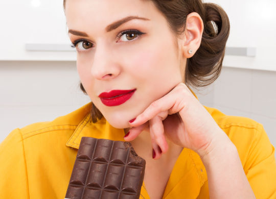 Stylish pin up girl with chocolate bar