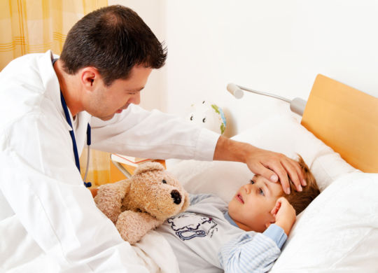 A physician house call. examines sick child.